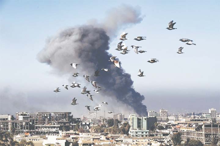 Smoke rises after an air strike in western Mosul on Monday during an offensive by Iraqi forces.