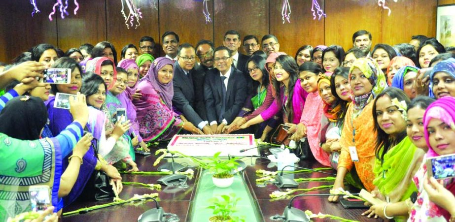Kazi Masihur Rahman, Managing Director and CEO of Mercantile Bank Limited inaugurating a program by cutting cake marking the International Women's Day at the bank's head office on Wednesday. Female employees of the bank participated in the program. Md Q
