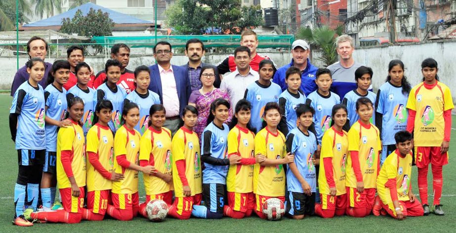 The youth female booters with the officials of Bangladesh Football Federation (BFF) pose for photographs at the BFF Artificial Turf on Wednesday. Bangladesh Football Federation observed the AFC Women's Football Day.