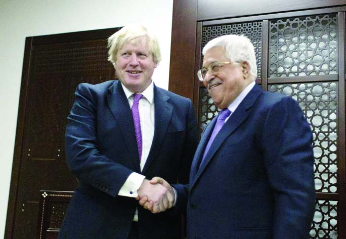 Palestinian President Mahmoud Abbas shakes hands with Britain's Foreign Secretary Boris Johnson during their meeting in the West Bank city of Ramallah on Wednesday.