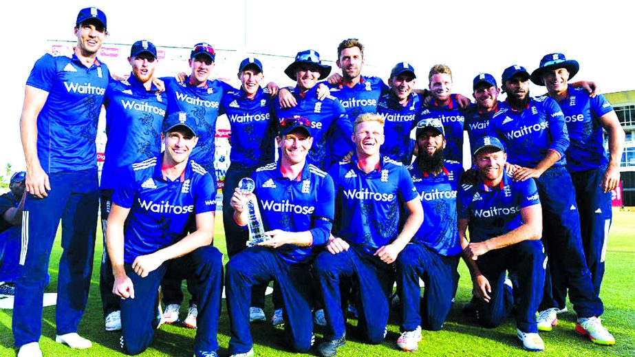 England's victorious cricketers pose with the series trophy after defeating West Indies in the 3rd ODI at Barbados on Thursday.