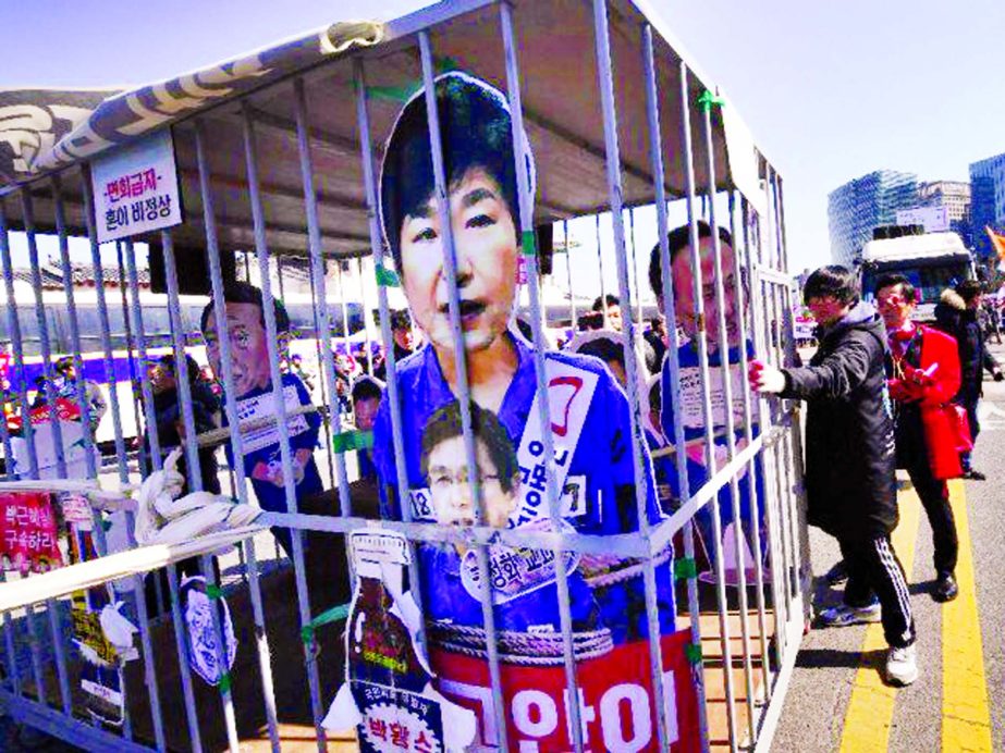 Anti-government activists celebrate as South Korean President Park Geun-Hye is fired by the country's top court.