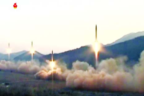 This screen grab taken from North Korean broadcaster KCTV shows ballistic missiles being launced during a military drill from an undisclosed location in North Korea.