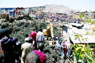 Rescue workers search for those buried by a landslide that swept through a massive garbage dump, killing more than a dozen people and leaving several missing at Koshe rubbish tip in Kolfe Keranio district of Addis Ababa, Ethiopia on Sunday.