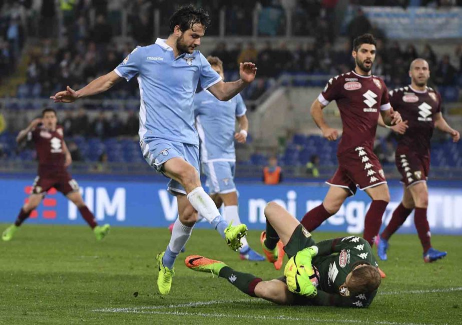 Torino goalkeeper Joe Hart saves on Lazio's Marco Parolo, during the Italian Serie A soccer match between Lazio and Torino at the Olympic Stadium in Rome on Monday.