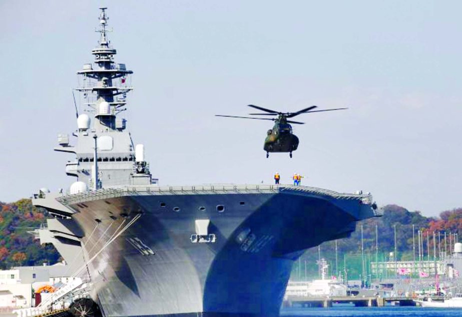 A helicopter lands on the Izumo, Japan Maritime Self Defense Force's helicopter carrier at JMSDF Yokosuka base, south of Tokyo.