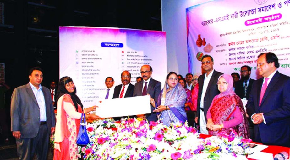 State Minister for women and children affairs Meher Afroz Chumki handing over replica of a cheque for Tk 50 Lac financed by ONE Bank Limited to a women entrepreneur at the Banker-SME women entrepreneur conference & product display fair 2017 in Dhaka recen