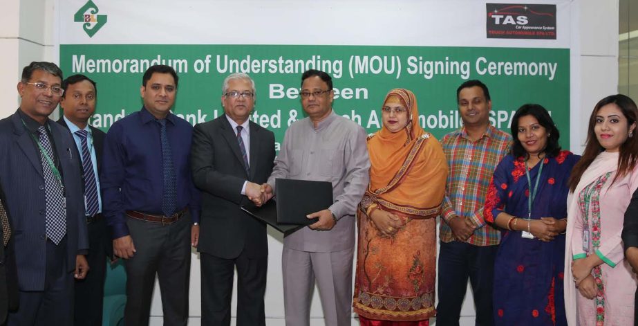 Md Sakhawatur Rahman, Head of BMOD of Standard Bank Limited (SBL) and Kazi Md Nizam Uddin, Managing Director of Touch Automobiles Spa Ltd (TASL) exchanging documents after signed an agreement in the city recently. Under the deal, SBL cardholders and emplo