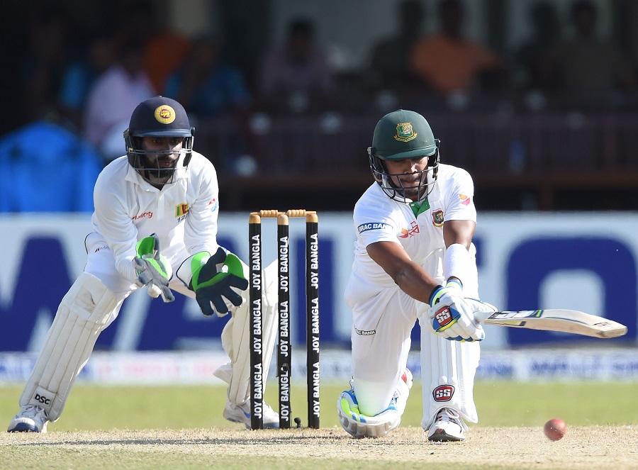 Bangladesh cricketer Sabbir Rahman (R) plays a shot as Sri Lankan wicketkeeper Niroshan Dickwella (L) looks on during the second day of the second and final Test cricket match between Sri Lanka and Bangladesh at The P. Sara Oval Cricket Stadium in Colombo