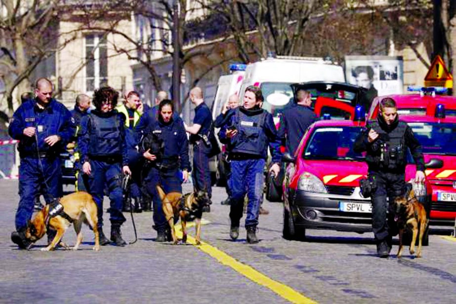 Police dogs join officers at the scene in west Paris.