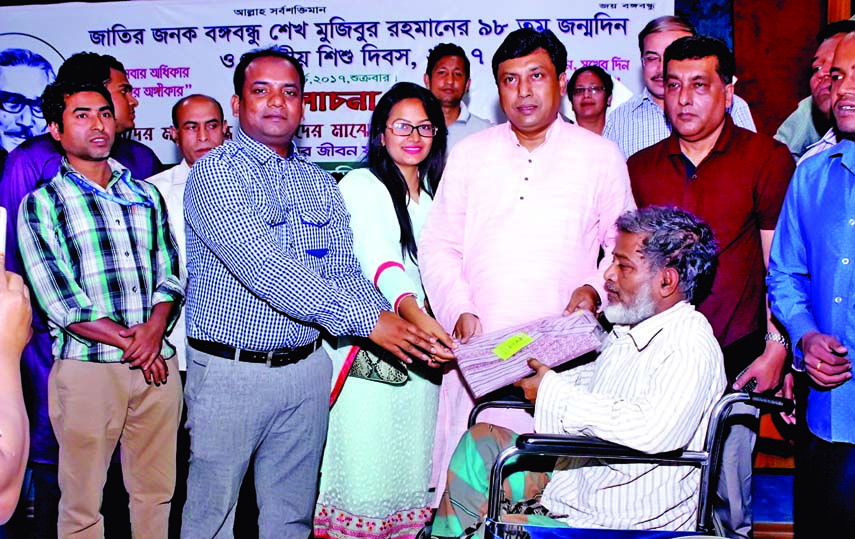 Director of the Shaheed Suhrawardy Medical College and Hospital Prof Dr Uttam Kumar Barua and President of Sundar Jibon Foundation Md Baki Billah distributing panjabee among the poor patients of the hospital in its auditorium in the city on Friday marking