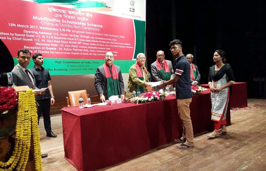 Finance Minister Abul Maal Abdul Muhith, MP distributing cheques at a scholarship distribution programme held at Bangladesh National Museum on Wednesday jointly organized by the High Commission of India and Muktijuddho Academy.