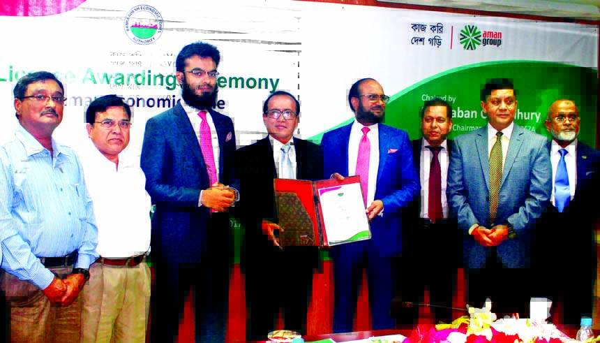 Paban Chowdhury, Executive Chairman of Bangladesh Economic Zone Authority (BEZA) handing over a Pre-Qualification license to Rafiqul Islam, Chairman of Aman Economic Zone Limited in a program held at BEZA Head Office in the city on Thursday. Dr. M Emdadul