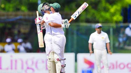 Shakib Al Hasan (L) is embraced by Mosaddek Hossain for his century on the 3rd day of 2nd Test between Bangladesh and Sri Lanka at P Sara Oval in Colombo on Friday.