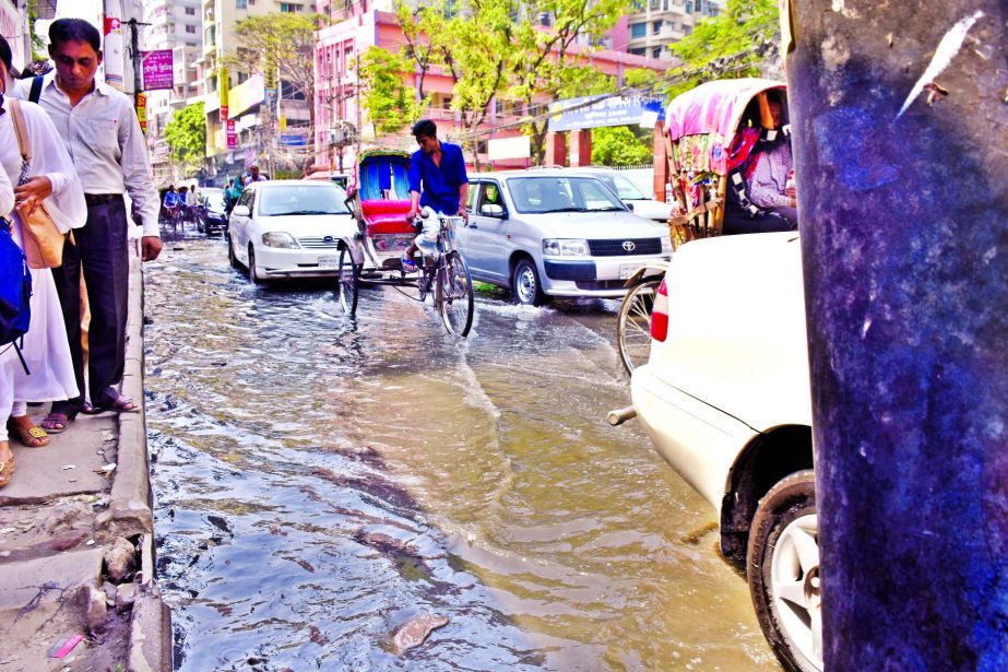 Main thoroughfare in city's Shiddheswari area is in a dilapidated condition as stench sewerage water being stagnant due to poor drainage system causing sufferings to commuters and school children under the very nose of the authority concerned. This phot