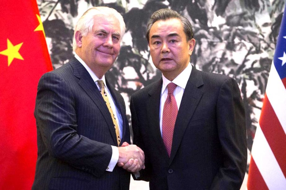 US Secretary of State Rex Tillerson, left, and Chinese Foreign Minister Wang Yi shake hands at the end of a joint press conference following their meeting at the Diaoyutai State Guesthouse in Beijing, China on Saturday.