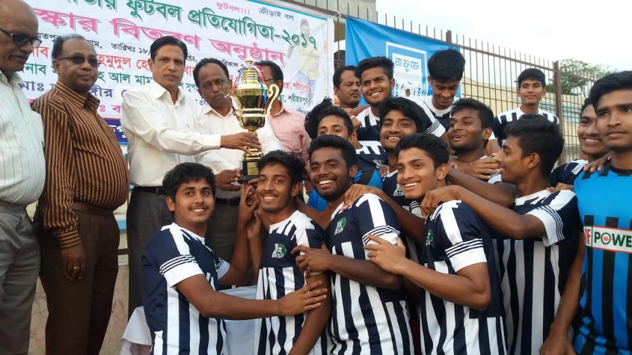 Members of BKSP, the champions of the Shariatpur Zone of the Under-18 National Football Championship receiving the trophy from DC of Shariatpur Md Mahmudullah Hossain at Shariatpur on Saturday.