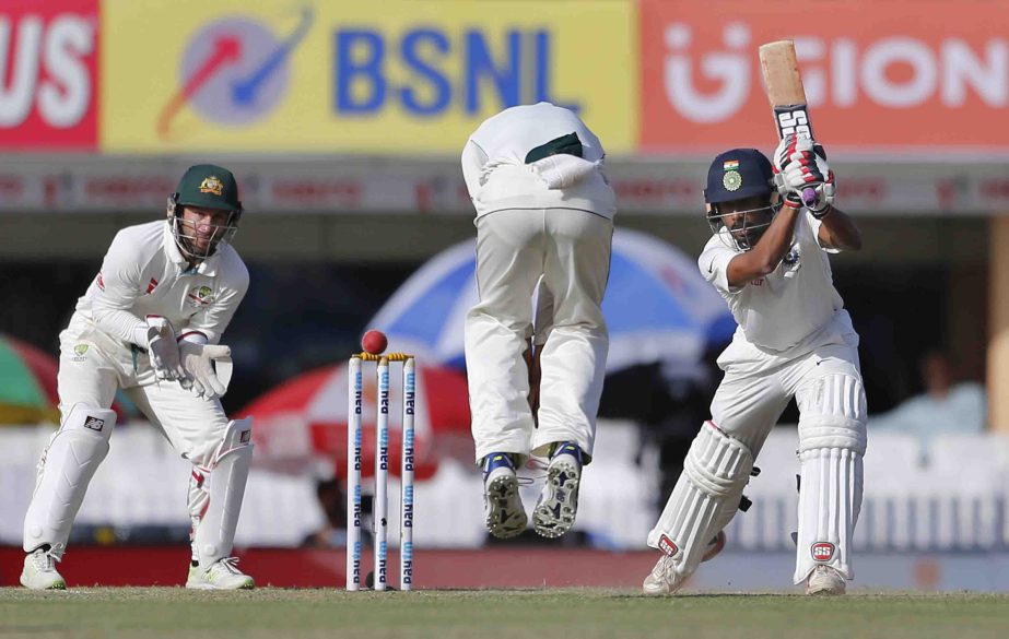 India's Wriddhiman Saha (right) plays a shot during the third day of their third Test cricket match against Australia in Ranchi, India on Saturday.