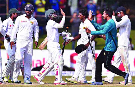 Bangladesh captain Mushfiqur Rahim (C) and teammates celebrate their victory over Sri Lanka by four wickets on the fifth and final day of the second and final Test cricket match at the P. Sara Oval Cricket Stadium in Colombo on Sunday. Internet photo