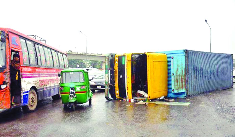 A goods-laden covered van overturned at the turning point beneath the city's Kuril Flyover near Radisson Hotel early Monday. Accidents is a regular feature there due to reckless driving.