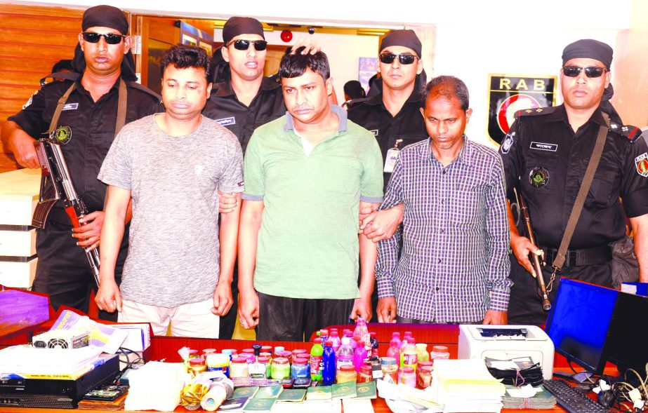 Rapid Action Battalion arrested three persons from city's Jatrabari area alongwith fake passports, visas, tickets from their possessions. This photo was taken from RAB Media Centre on Monday.