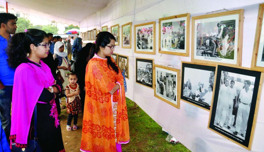 Visitors at a photo exhibition organised on the occasion of 98th birthday of Bangabandhu Sheikh Mujibur Rahman at Azimpur School playground in the city on Tuesday.