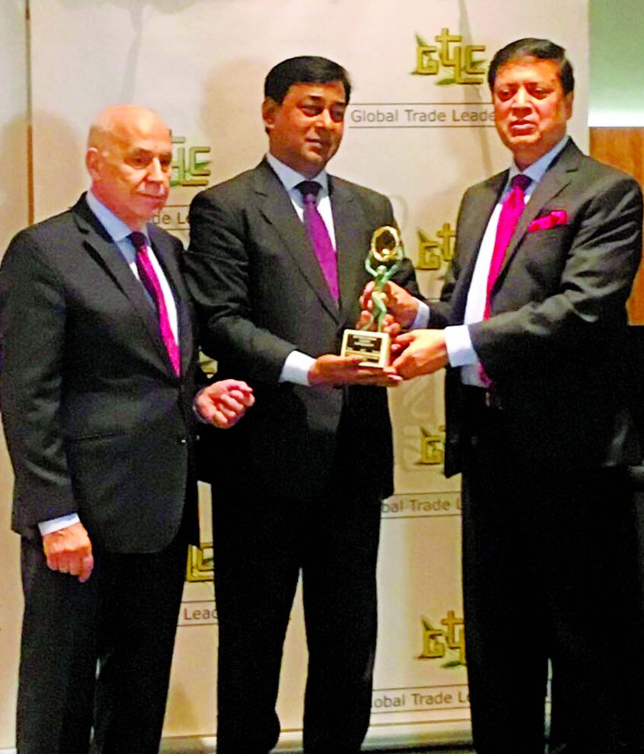 Muhammed Ali, Managing Director of United Commercial Bank Limited receiving the 'International Trophy for Quality' by Global Trade Leaders' Club from Recardo Rose Lopez, General Secretary of the Club, recently. M Shahidul Islam, Ambassador of Banglades