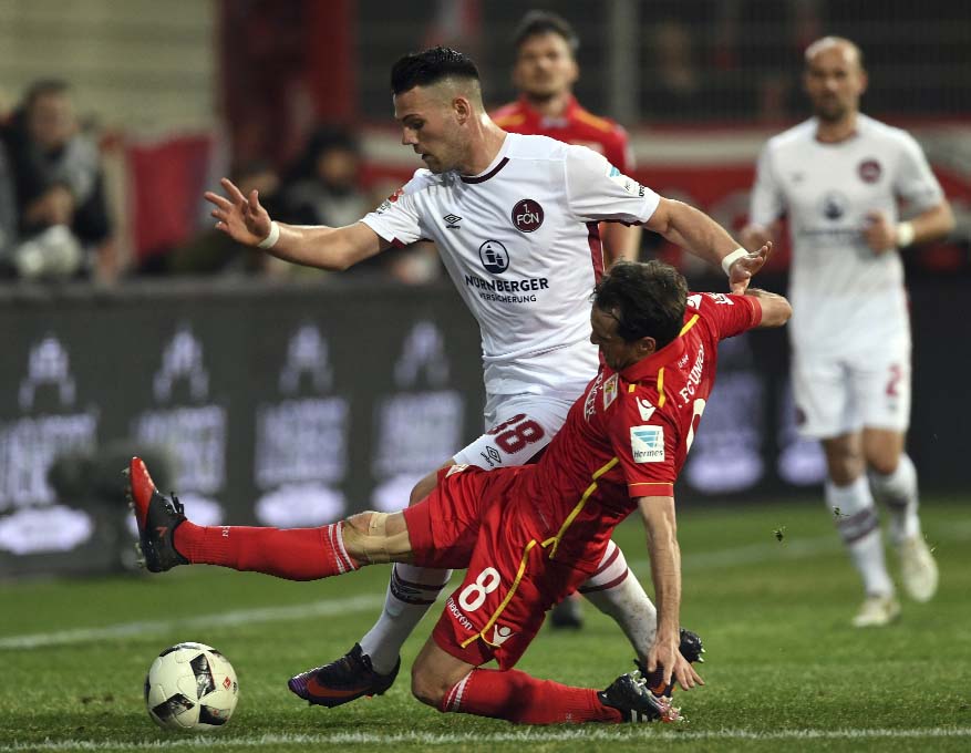 Berlin's Stephan Fuerstner (right) and Nuremberg's Eduard Loewen in action during the 2nd Bundesliga soccer match between FC Union Berlin and FC'Nuremberg at the Stadion An der Alten Foersterei in Berlin, Germany on Monday.