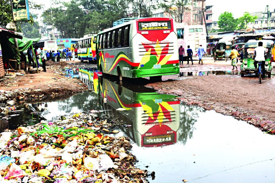 The condition of the Postagola road near Buriganga Bridge is in sorry state for last few days as sewerage water overflowed the main street causing sufferings to commuters as well as pedestrians. This photo was taken on Wednesday.