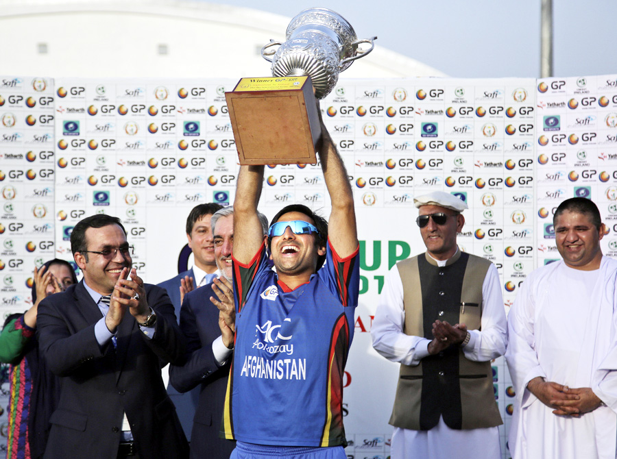 Asghar Stanikzai lifts the series trophy after winning 5th ODI against Ireland in Greater Noida on Friday.