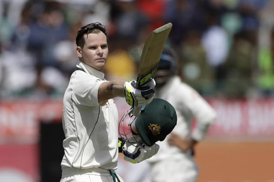 Australia's captain Steven Smith raises his bat after scoring century during the first day of their fourth Test cricket match against India in Dharmsala, India on Saturday.