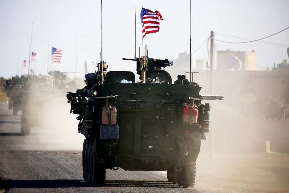 Convoy of US armoured vehicles drives near the village of Yalanli, on the western outskirts of the northern Syrian city of Manbij.