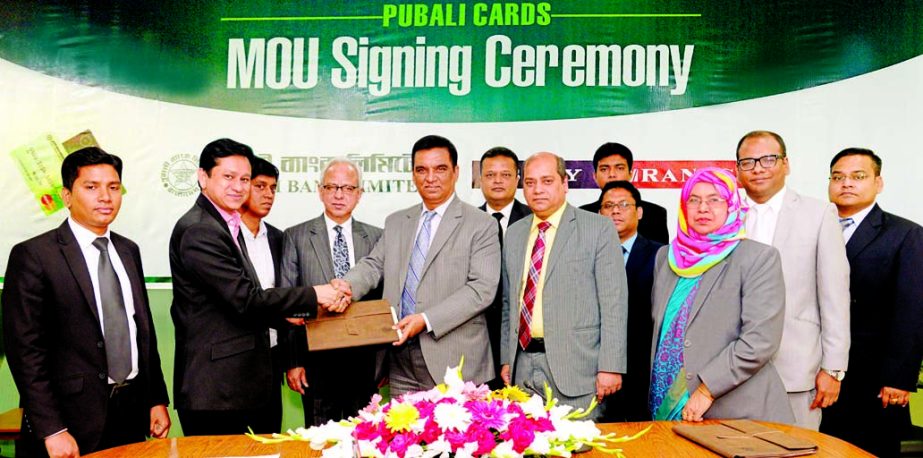 Md Abdul Halim Chowdhury, Managing Director of Pubali Bank Limited and Md Sarwar Jahan Chowdhury, National Sales Manager of Rangs Electronics Ltd, exchanging documents of a MoU signing in the city recently. Under the deal employees, Credit and Debit card