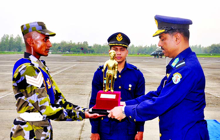 Air Officer Commanding of Bangladesh Air Force Base Bir Sreshto Matiur Rahman Air Commodore Sheikh Abdul Hannan awarding " Best Recruit Trophy ' to Md Hasibul Islam for his best performance in the course on Tuesday. Photo: ISPR"