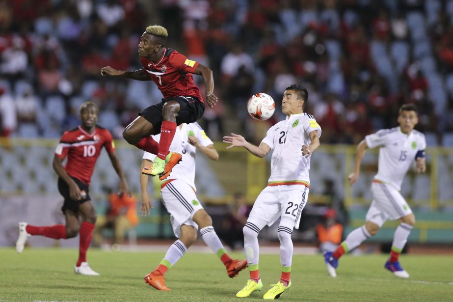 Mexico's Jurgen Damm controls the ball as Trinidad and Tobago's Cordell Cato go for a header during a 2018 World Cup qualifying soccer match in Port of Spain, Trinidad and Tobago on Tuesday.