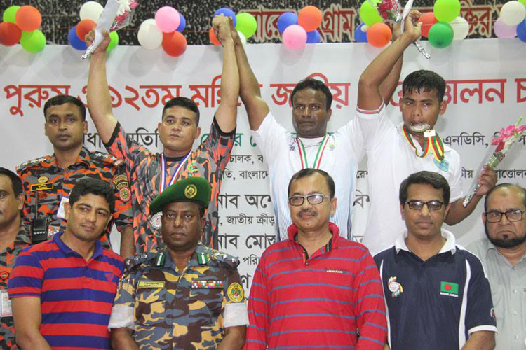 The winners of the ARK Group 35th National Weightlifting (Men's) Championship with the officials of different federations pose for a photo session at the gymnasium of National Sports Council on Thursday.
