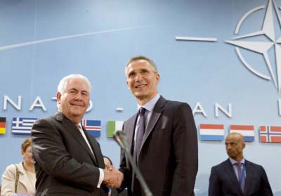 U.S. Secretary of State Rex Tillerson, left, shakes hands with NATO Secretary General Jens Stoltenberg during a meeting of the North Atlantic Council at NATO headquarters in Brussels on Friday.