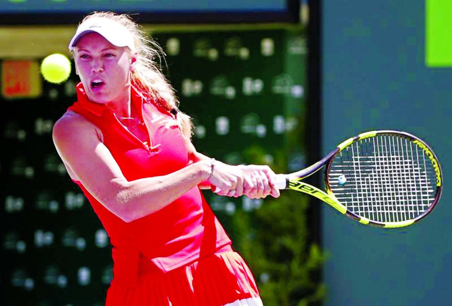 Caroline Wozniacki of Denmark returns a shot from Karolina Pliskova of the Czech Republic during a tennis match at the Miami Open in Key Biscayne, Fla on Thursday.