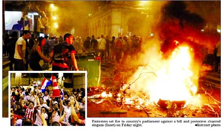 Protesters set fire to country's parliament against a bill and protesters chanted slogans (Inset) on Friday night. Internet photo