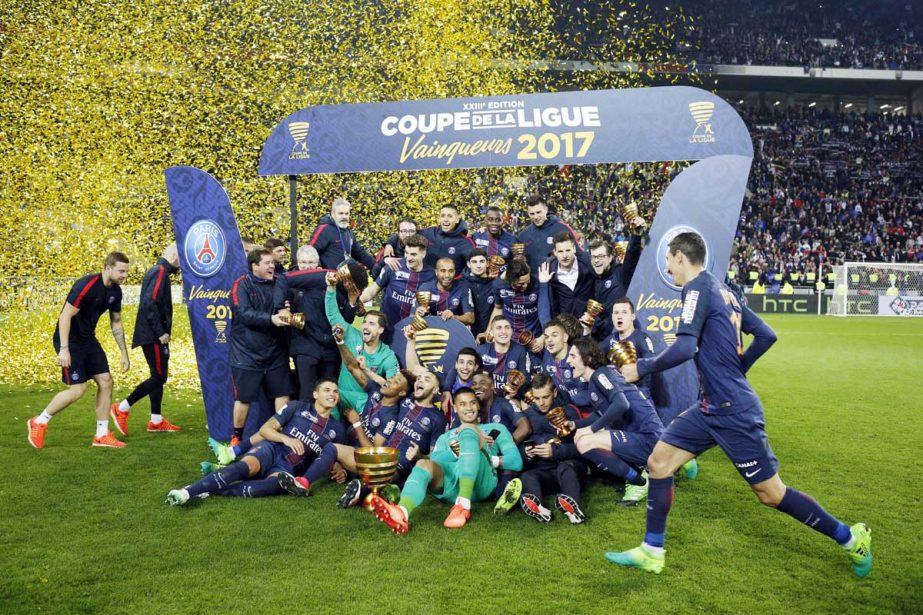 Paris Saint Germain' players celebrate with their trophies after winning the League Cup final soccer match against Monaco, in Decines, near Lyon, central France on Saturday.