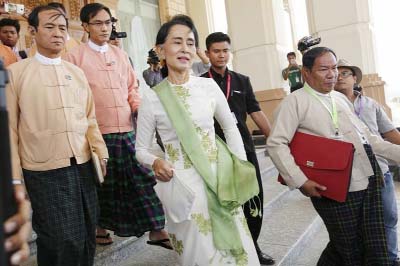 National League for Democracy (NLD) party leader Aung San Suu Kyi leaves the parliament building after a meeting with members of her party in Naypyitaw.