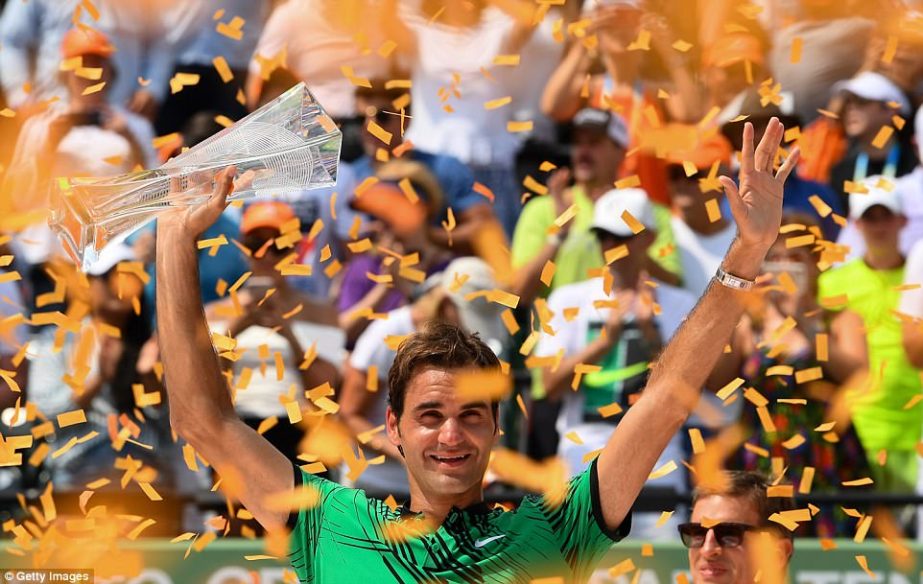Roger Federer proudly holds the Miami Open trophy following his 6-3, 6-4 victory over Rafeal Nadal on Sunday evening.