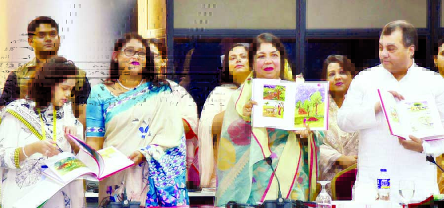 Speaker Dr Shirin Sharmin Chaudhury along with other distinguished persons holds the copies of an art book titled 'Unique Glimpses' collected and edited by Saima Wazed Hossain on its cover unwrapping ceremony at Bangabandhu International Conference Cen