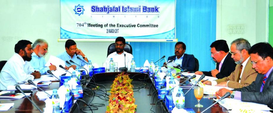 Md Sanaullah Shahid, Chairman of the EC of Shahjalal Islami Bank Limited presiding over its 704th meeting at the bank head office in the city recently. Mohiuddin Ahmed, Vice-Chaiman of the Board of Directors, Akkas Uddin Mollah, Mohammad Younus, Khandaker