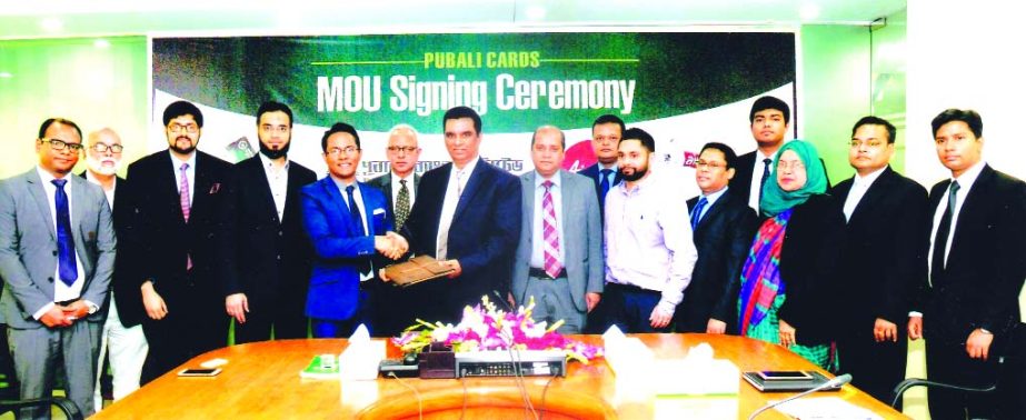 Md. Abdul Halim Chowdhury, Managing Director of Pubali Bank Limited and Morshedul Alam Chaklader, CEO of Air Asia Bangladesh, exchanging documents after signing an MoU in the city recently. Under the deal, all cardholders and officers of the bank will ava