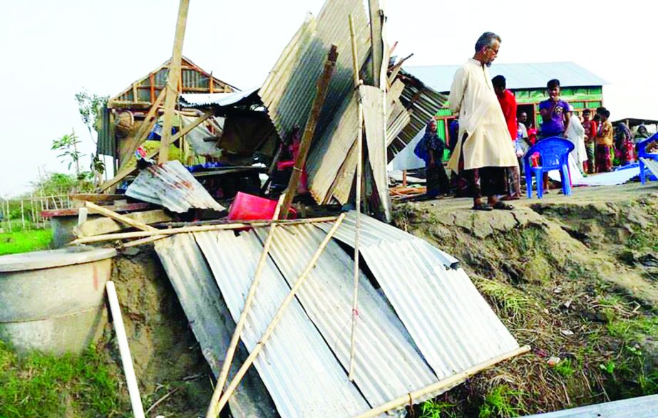 COMILLA: Nor'wester damaged houses and trees at Bijoynagar village in Homna Upazila on Tuesday.