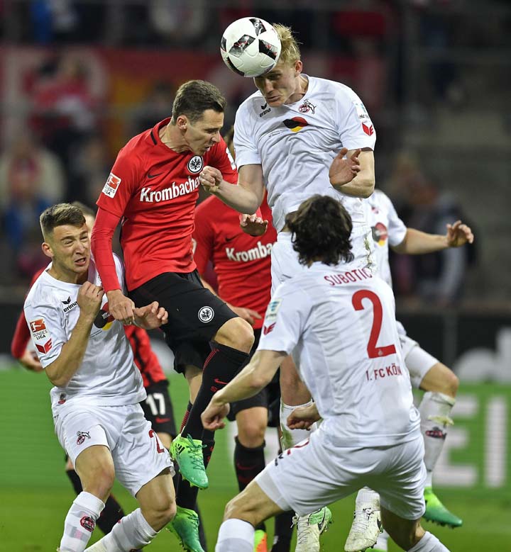 Cologne's Frederik Soerensen (up) heads the ball during the German Bundesliga soccer match between 1. FC Cologne and Eintracht Frankfurt in Cologne, Germany on Tuesday.