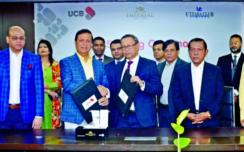 Muhammed Ali, Managing Director of United Commercial Bank Limited and Nasir U Mahmood, President of Uttara Club Limited, exchanging a MoU signing documents in the city on Thursday. MA Sabur, Chairman, Anisuzzaman Chowdhury, Vice Chairman and M A Hashem, D