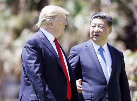 President Donald Trump, left, and Chinese President Xi Jinping walk together after their meetings at Mar-a-Lago, in Palm Beach, Fla.
