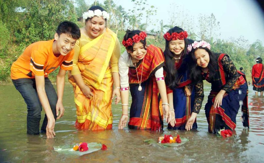 Tribal people floating flowers in the Kaptai Lake on the occasion of 3 -day long Boisabi Festival on Wednesday.